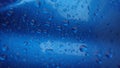 Rain drops on a blue motorcycle tank. Royalty Free Stock Photo