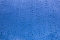Rain drops on a blue vehicle bodywork. Wet background