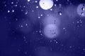 Rain drops with bokeh effect in the night city. Drops of rain on window with abstract lights Royalty Free Stock Photo