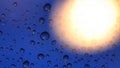 Rain drops or bubbles on the window glass and the sun shines from behind Royalty Free Stock Photo