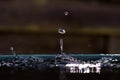 Rain drops in a bucket in the light of the sun