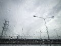 Rain drops on the car glass with pedestrian overpass on the road Royalty Free Stock Photo