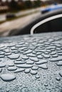 Rain drops on car paint threated with hydrophobic coating. Royalty Free Stock Photo