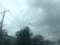 Rain drops on car`s windscreen with blurred stormy sky Royalty Free Stock Photo