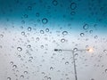 Rain drops on the car sunroof with lamp pole on the street backdrop