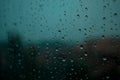 Rain drops on a crystal window at the evening with trees and sky background