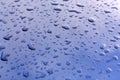 Rain drops on dark blue metal surface. Royalty Free Stock Photo