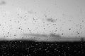 Rain drops and defocused sky background in black and white. Royalty Free Stock Photo