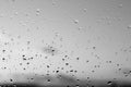 Rain drops and defocused sky background in black and white. Royalty Free Stock Photo