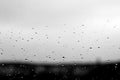 Rain drops and defocused sky background in black and white Royalty Free Stock Photo