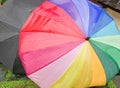 Rain drops falling onto umbella with rainbow colour Royalty Free Stock Photo
