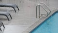 Rain drops falling on water of swimming pool, rainy in California motel or hotel Royalty Free Stock Photo