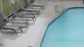 Rain drops falling on water of swimming pool, rainy in California motel or hotel Royalty Free Stock Photo