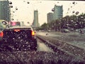 Rain drops in front of the car mirror. Royalty Free Stock Photo