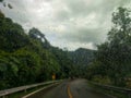 Rain drops on the front mirror while driving on the mountain road