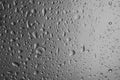 Rain drops on glass against grey background Royalty Free Stock Photo