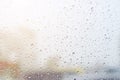 Rain drops on glass in cloudy weather with blurred background. Royalty Free Stock Photo