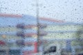 Rain drops on glass in cloudy weather with blurred background. Royalty Free Stock Photo