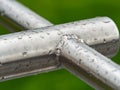 Rain drops on a gray metallic construction  of chrome bars Royalty Free Stock Photo