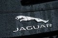 Rain drops on Jaguar logo on black car parked in the street Royalty Free Stock Photo
