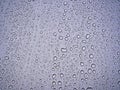 After the rain drops on light blue metal surface Royalty Free Stock Photo