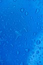 Rain drops on metal blue surface Royalty Free Stock Photo