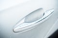 rain drops on modern handle on white car Royalty Free Stock Photo