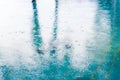 Rain drops motion blured rippling in a puddle with light and sh Royalty Free Stock Photo