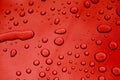 Rain drops on red car paint threated with hydrophobic coating Royalty Free Stock Photo
