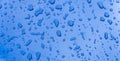 Rain drops on the red car surface. Water srops on car hood. Water drops on blue metal surface. Royalty Free Stock Photo