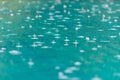 Rain drops on the surface of the pool.