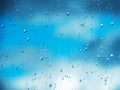 Rain drops on surface of the window glass with cloud background. Natural pattern of water drops on glass after last rain Royalty Free Stock Photo