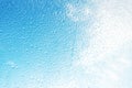 Rain drops on surface of the window glass with sky cloud background. Natural pattern of water drops on glass Royalty Free Stock Photo