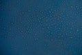 Rain drops texture. Wet raindrops water on glass background. Blue bubble pattern wallpaper. Royalty Free Stock Photo