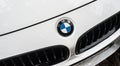 rain drops on white BMW car front parked in the street Royalty Free Stock Photo