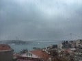 Rain drops on window against buildings in Istanbul, Turkey Royalty Free Stock Photo