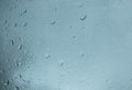 Rain drops on window against grey cloudy background Royalty Free Stock Photo