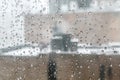 Rain drops on window with a city building on the background. Royalty Free Stock Photo
