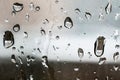 Rain drops on window with a city building on the background. Royalty Free Stock Photo