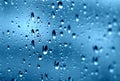 Rain. Drops on the window. Close on the glass. Shower. Wet glass. Blue background. Royalty Free Stock Photo