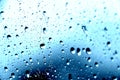 Rain. Drops on the window. Close on the glass. Shower. Wet glass. Blue background.