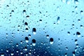 Rain. Drops on the window. Close on the glass. Shower. Wet glass. Blue background.