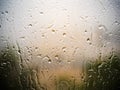 Beautiful drip of drops of rain on the window in the autumn cloudy day