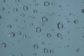 Rain drops on window glass. Natural blue water background Royalty Free Stock Photo