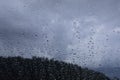 Rain drops window glass. Rainy day sky view through window Royalty Free Stock Photo