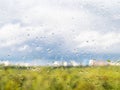 Rain drops on window glass and view of city park Royalty Free Stock Photo