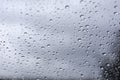 Rain drops on window glasses surface with cloudy background . Natural Pattern of raindrops isolated on cloudy background Royalty Free Stock Photo