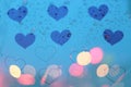 Rain drops on window with light bokeh on heart frame background. Royalty Free Stock Photo