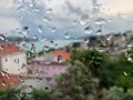 Rain drops on a window pain against city view Royalty Free Stock Photo