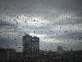 Rain drops on window pane against city view Royalty Free Stock Photo